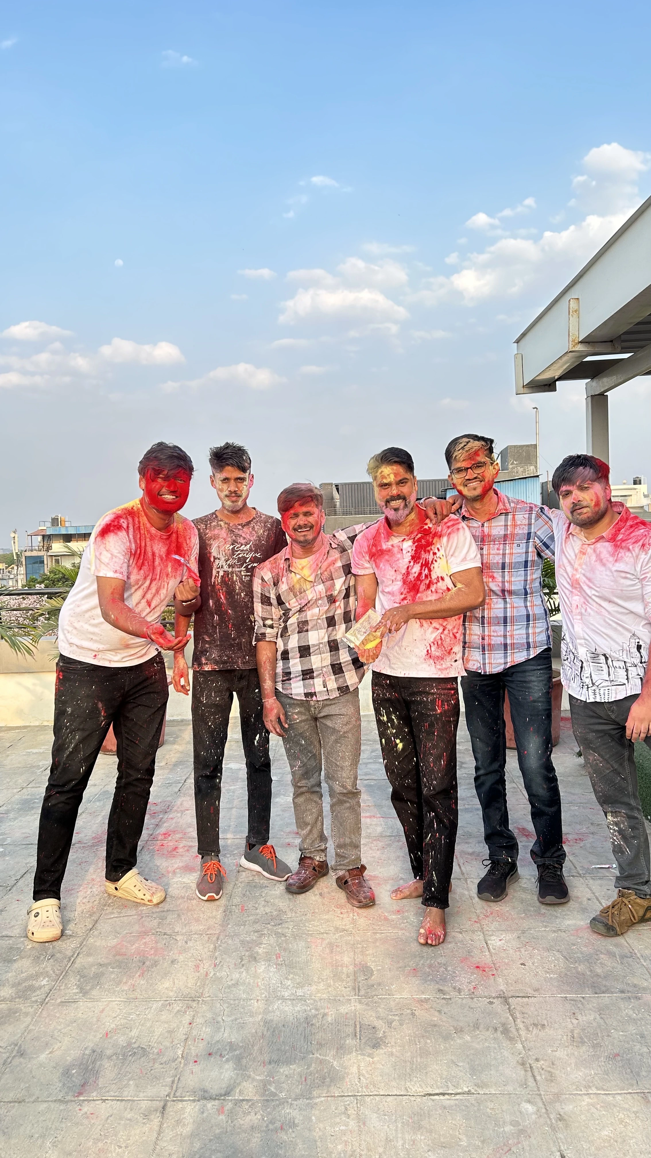 Holi on the office terrace with the team, everyone covered in colour